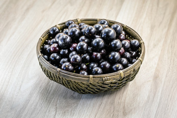 Fruit called Jaboticaba or jabuticaba in a basket on a white background, preserves organic and healthy fruits.