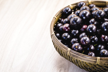 Fruit called Jaboticaba or jabuticaba in a basket on a white background, preserves organic and healthy fruits.