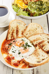 Sunny side up eggs with crsipy toast on the plate   