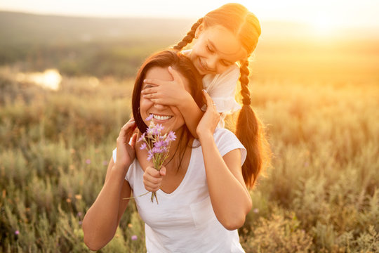 Girl Giving Flowers To Mother