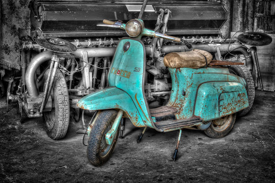 A pic of a very old turquoise scooter