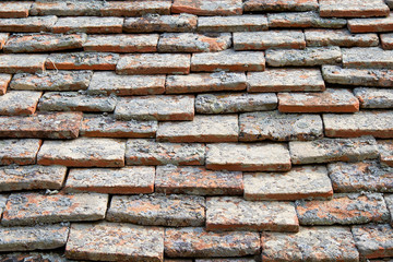 Texture of terracota tiles. Old weathered tile roof background