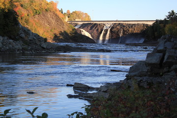 Waterfalls and river in autumn. Public park and Power plant