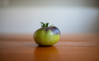 An heirloom tomato on the kitchen table