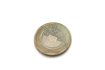 A close up image of a bimettalic one thousand Colombian peso coin isolated on a clean, white background