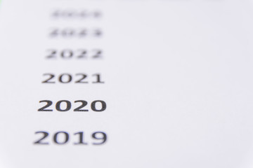 Fototapeta premium List of recent years on white paper. Focus on 2020. Copy Space