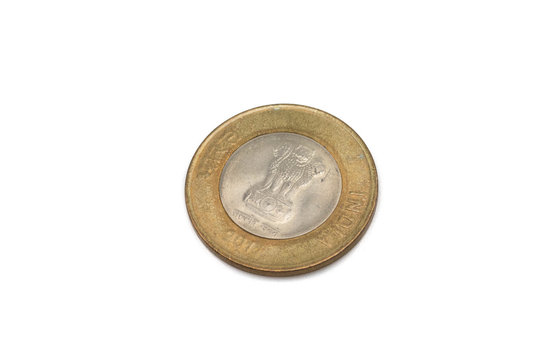 A gold and silver, ten Indian rupee coin isolated on a white background.  Shot close up in macro