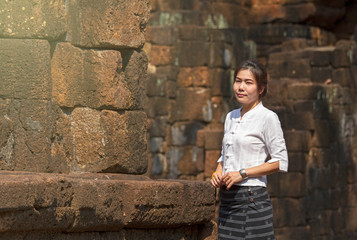 Thai women dressed in traditional costumes walk to visit the ancient sites.