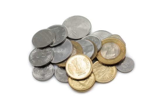 A close up, macro photo of a pile of Indian coins, in a pile, isolated on a white background