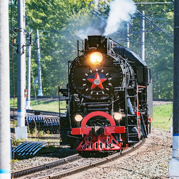 Image of the retro steam train at summer day time.