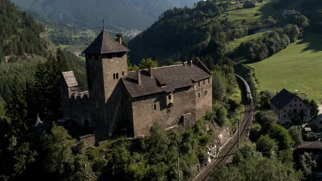 ancient austrian fortress schloss wiesberg with a train passing by