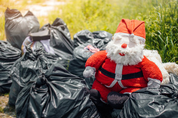 Santa Claus doll is dumped in a dump. garbage.