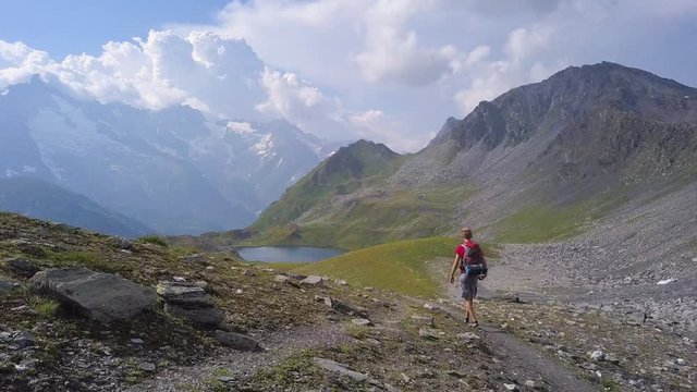 Hiker walking on trail near Frenetre Lake, Grand St Bernard, Switzerland, Europe