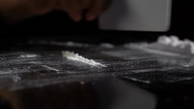 Strips of white cocaine powder on a table