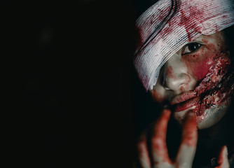 Close-up zombie women looks at her with resentment in an abandoned building, Halloween murder...