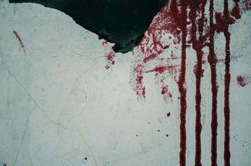 The wall of an abandoned building filled with blood, Halloween murder concept.
