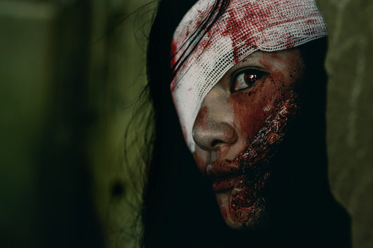 Close-up zombie women looks at her with resentment in an abandoned building, Halloween murder concept.