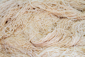 Yellow noodles or Mee Sua food drying in the sunlight Making sun dried in Thailand are Chinese noodle vegetable in vegetarian festival.