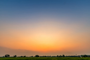 Obraz na płótnie Canvas blue bright dramatic sunset sky cuts the orange color in countryside or colorful cloudscape texture air background.