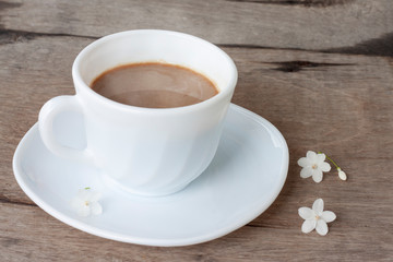 A cup of hot coffee on wooden table for the new morning.