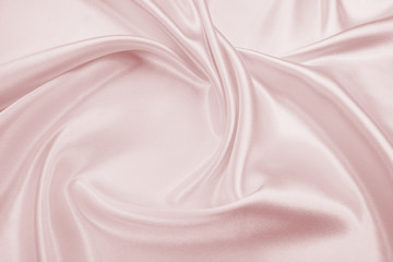Fototapeta premium Delicate satin draped fabric pink texture for festive backgrounds