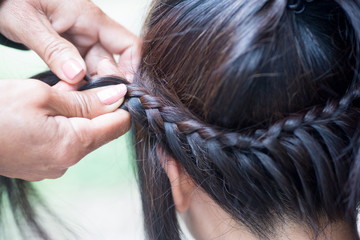 Naklejka premium Weave girls braids in Home.