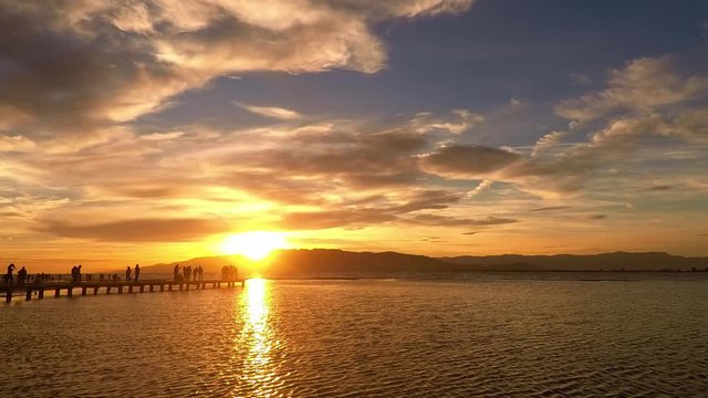 Timelapse of sunset over Badia dels Alfacs and Trabucador dock (Sant Carles de la Rapita, Catalonia). Sky in flames.