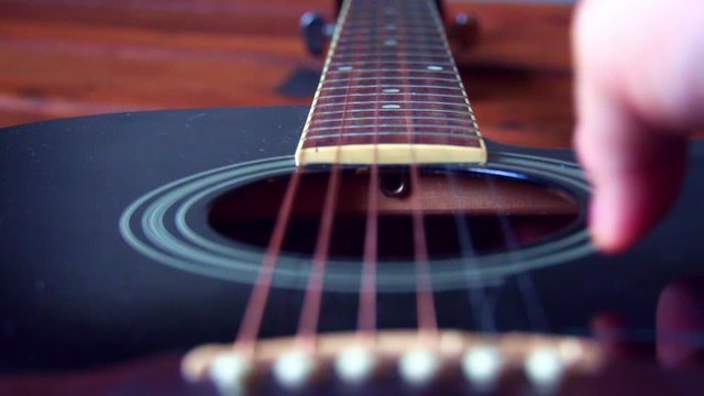 Guitar String vibrating in slow motion,  Close up