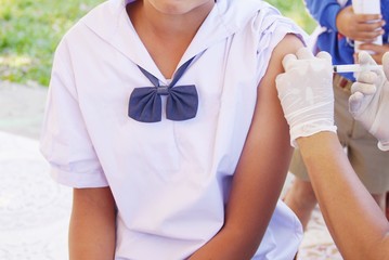 Fototapeta premium The doctor vaccinated the school children .