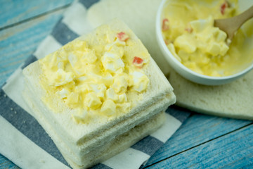 Boiled egg mixed with salad cream on white bread