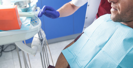 Man sitting in a dental chair in the clinic.