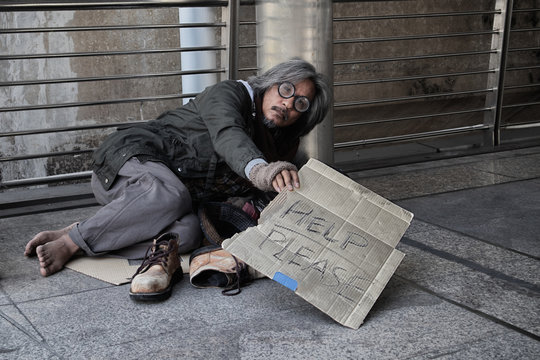 The lives of the homeless or beggar are sad, dirty, poor, hungry, tired, fear and want to have a home, clothes, food, and money. Man waits for an opportunity from the person to help them.