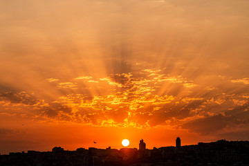 Sun rays float through the clouds at sunset