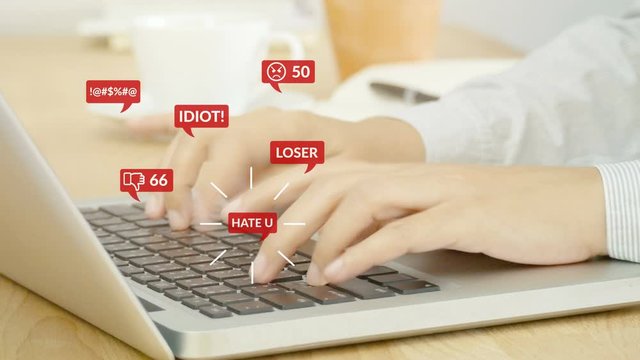 4K. people using notebook computer laptop for social media interactions with notification icons of hate speech and mean comment in social network, cyber bullying concept.