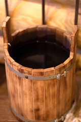 .wooden bucket with hot water from the Russian wooden hot bath