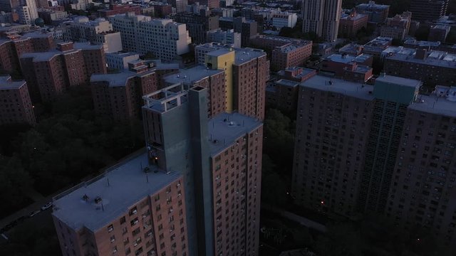 Beautiful aerial rollup from housing project highrise buildings to reveal the sunrise skyline.  in 4K.