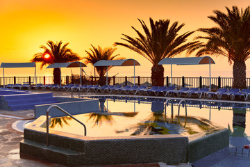 Beach hotel resort with pool at dawn
