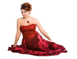 young woman sitting in red dress.