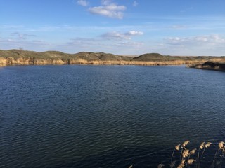 Big lake on a background of cloudy sky
