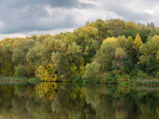 Fototapeta premium Autumn, river, trees, foliage, clouds.