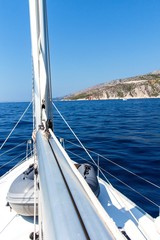 Fototapeta na wymiar Sailing boat near Hvar island Croatia - Europe. Sailing on the Adriatic Sea. View from the deck of a rocky island. Holiday in Croatia