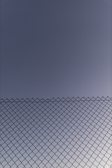 wire fence at sunset with unfocused background