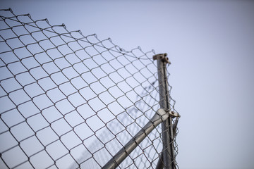 wire fence at sunset with unfocused background