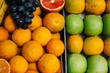 Assortment of exotic fruits close-up. orange, apple, grapefruit,  grapes,