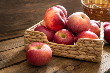 Apples lie on wooden planks, ripe red fruits