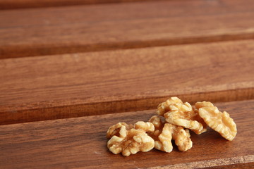 Peeled walnuts on wooden background