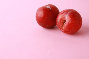 Delicious plums in colorful background