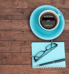 Hello weekend wrote on blue coffee cup over grunge wood background