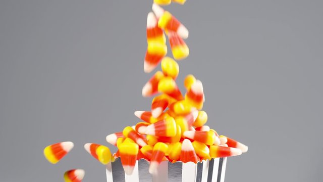 Time for Halloween. Delicious candy corn falls in slow motion.