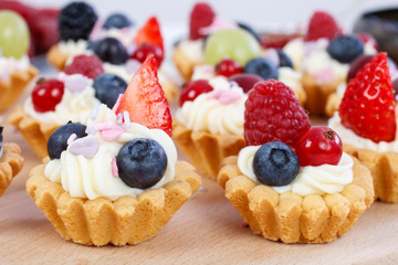 Colorful cupcakes with fresh fruits.